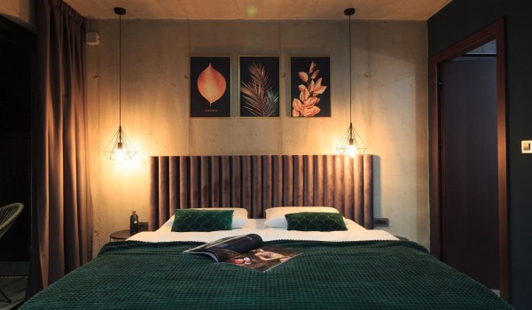 Double bed with furnished emerald green bedding in a modern villa for rent on the island of Krk