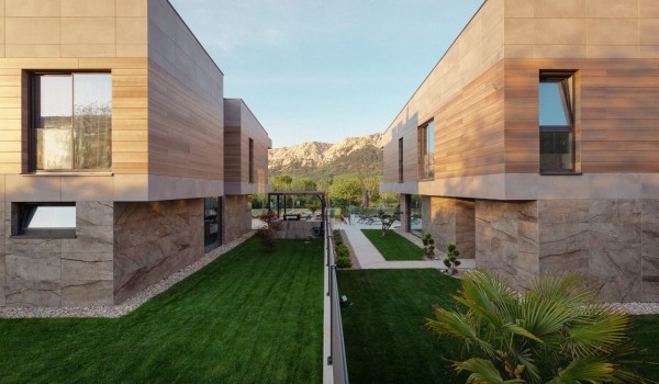 Modern villa Krk Baska II on the island of Krk with a garden decorated with greenery and lawn.