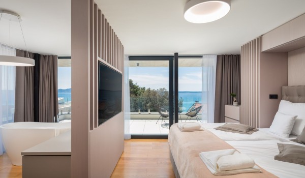 Spacious air conditioned master bedroom with queen size bed, LCD TV, en suite bathroom and a large terrace with garden furniture of the Luxury Villa Sea and View