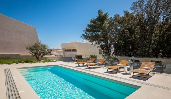 Private heated and covered hydro massage pool, sun deck with loungers and seating set in front of the Luxury Villa Sea and View Petrcane