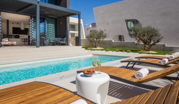 Front view on the Luxury Villa Sea and View Petrcane with a pool in the loungers and a small table by the pool