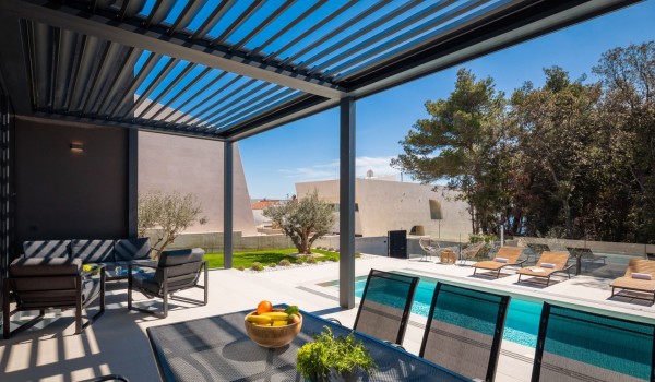Terrace of the Villa Idria Sea and View Petrcane with dining set and a seating area overlooking the pool and yard