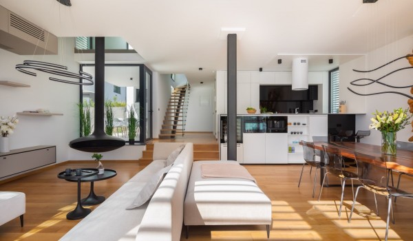 Ground floor of the Villa Idria Sea and View Petrcane; living room with sofas and hanging fireplace, framed windows and open staircase, a kitchen with kitchen island and dining set for 8
