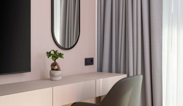 A corner with a desk and chair, mirror and LCD TV in the elegantly decorated bedroom on the first floor of the Luxury Villa Idria