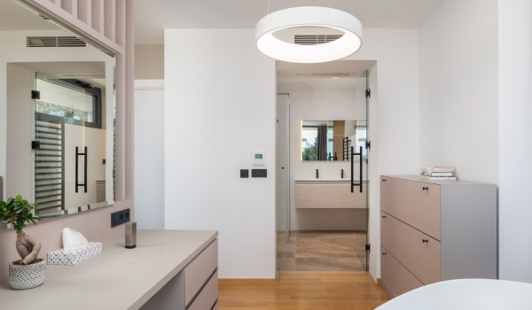 A view on an en suite bathroom with a shower from the bathtub area separated with room dividers from the master bedroom on the second floor of Villa Idria Sea and View
