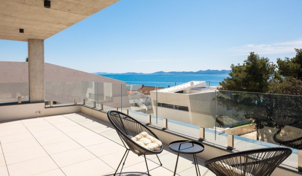 Sea view from the spacious terrace of the master bedroom; a seating set of two chairs and a coffee table