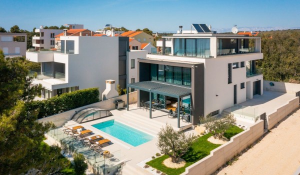 The whole property of Luxury Villa Idria Sea and View with a private garage, 4 parking places, heated hydro massage pool, patio with loungers and greenery with olive trees