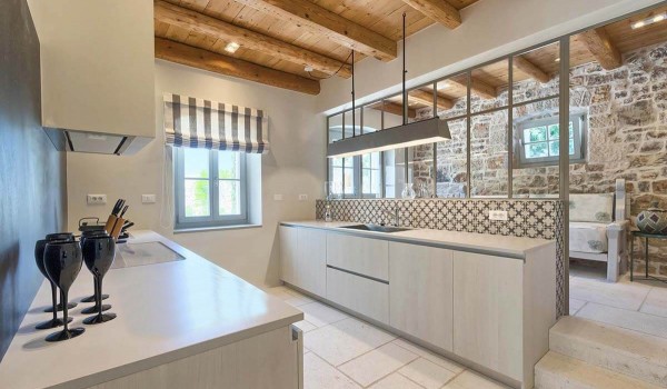 Modern, minimalist kitchen with stove, sink and kitchenware