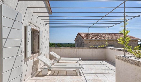 Two sun loungers on the private balcony of the luxury villa with pool in Radovani