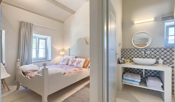 Minimalist bedroom with a double bed and an en suite bathroom in the family villa for rent in Istria
