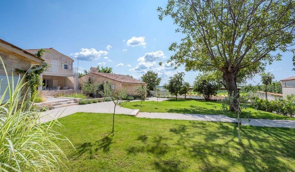 Landscaped lawn in the private yard of the luxury villa for rent and vacation Deluxe Manor Baderna in Istria