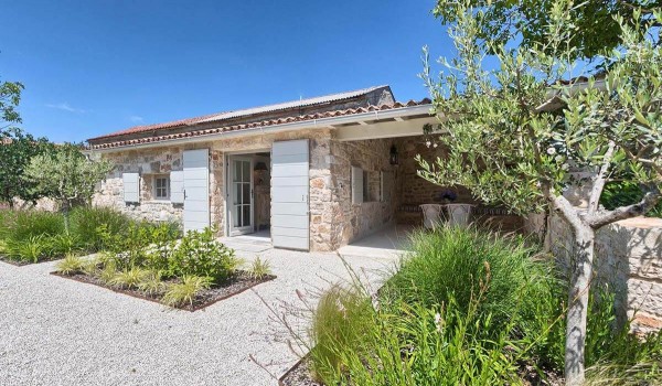 View of the house by the pool on the property of the luxury villa Deluxe Manor Baderna with pool in Istria