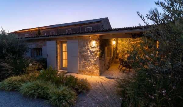 Roofed terrace and entrance to the house next to the pool on the landscaped property of a family villa with pool in Radovani