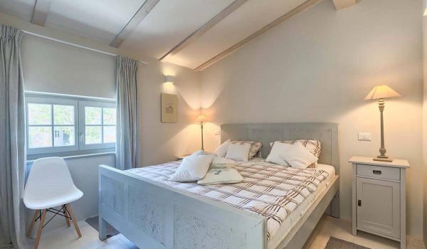 Bright colors in the interior of the bedroom with a double bed, a nightstand and a chair