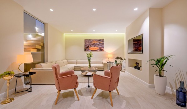 Illuminated, air-conditioned living room with corner sofa and armchairs in the luxury villa for family vacation Raquel on the island of Šolta