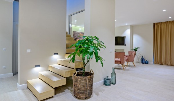 The interior of an elegantly decorated living room with a staircase of a villa with a swimming pool for rent and vacation by the sea Raquel on Šolta with Internet, SMART TV and private parkin