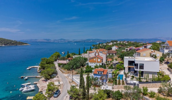 A view of the fenced private property of the luxurious villa Raquel with a swimming pool, gym and private parking for eight people by the sea and the beach on the island of Šolta