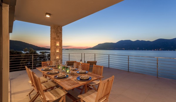 Outdoor dining table on the terrace with sea view in the luxury pool villa for vacation with friends on Korcula island