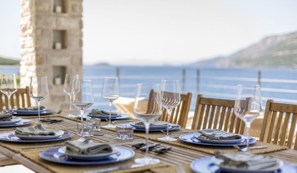 Outdoor dining table with sea view on the terrace of a luxury family villa for vacation and rent on Korcula island
