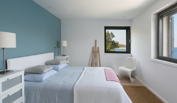 King size bed in a bedroom with sea view in a luxury Korcula villa for vacation with friends