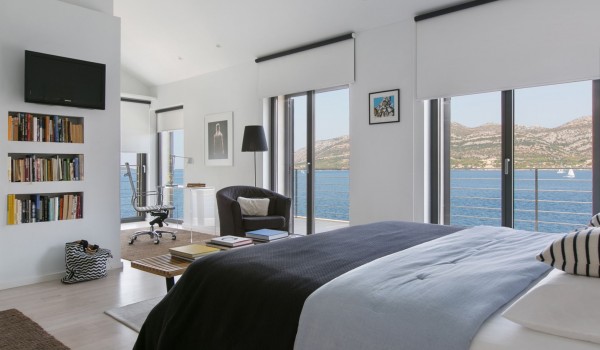 King size bed in a bedroom with sea view in a luxury Korcula villa for vacation with friends