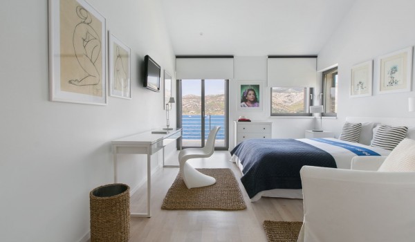King size bed in a bedroom with sea view in a luxury Korcula villa for vacation with friends