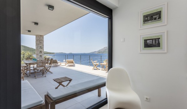View of the terrace with lounge chairs in a luxury Croatian villa for summer vacation on Korcula island
