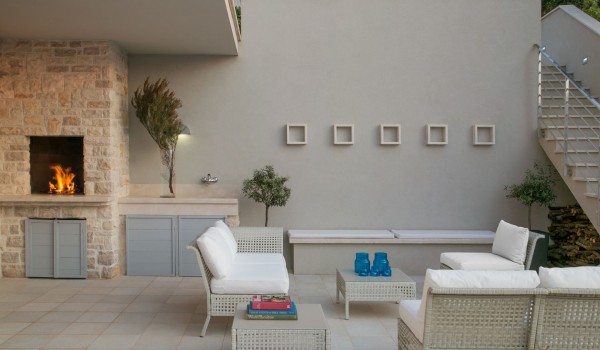 Outdoor seating area and grill on the terrace of a luxury vacation villa Korcula Beach Retreat