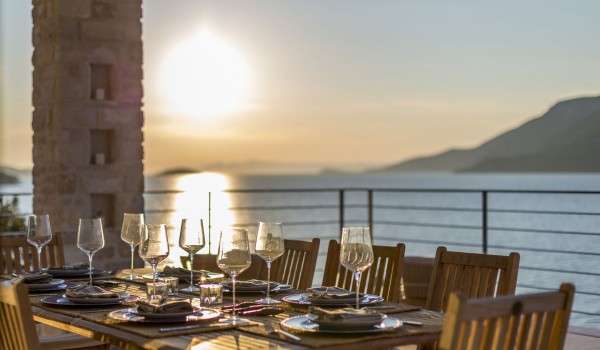 Outdoor dining table overlooking the sea on the terrace of a luxury island villa Korcula Beach Retreat  with private pool