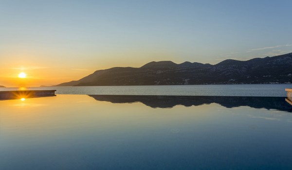 View of the sea and sunset from the private infinity pool of a luxury  villa For vacation with friends on Korcula island