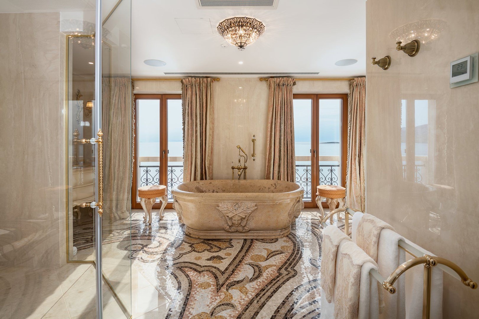 En-suite-Marmorbad mit Badewanne und Dusche in einem luxuriösen Familienapartment mit Privatparkplatz und Whirlpool