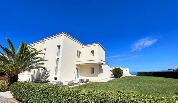 View of the luxury villa Residenzia Imperiale in Savudrija in Istria and its fenced yard with a landscaped garden and lawn