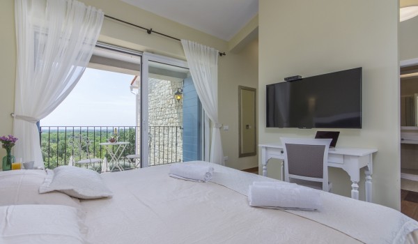 Cozy bedroom in luxury holiday villa Stella Istriana in Višnjan with King-size bed and sea view.