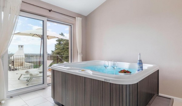 Jacuzzi with garden view in Istra luxury family villa for vacation and rent with sea view.