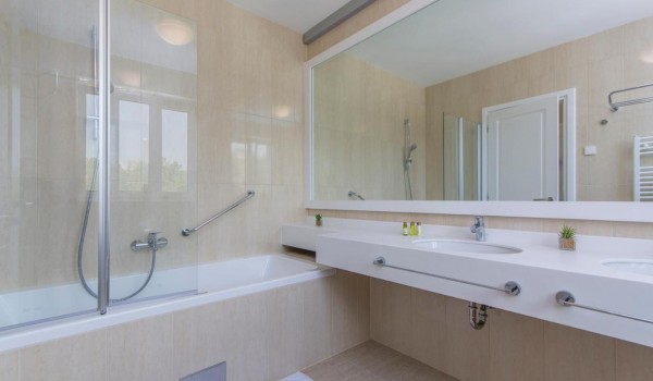 En suite air -conditioning bathroom with bathtub and shower in luxury family villa in Istria with pool. sauna and jacuzzi.