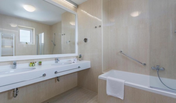 En suite air -conditioning bathroom with bathtub and shower in luxury family villa in Istria with pool. sauna and jacuzzi.