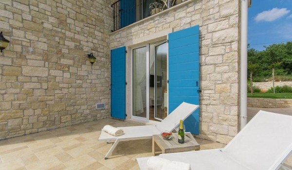 Deck chairs on sunny terrace of luxury rental villa in Istra with parking, pool and jacuzzi.