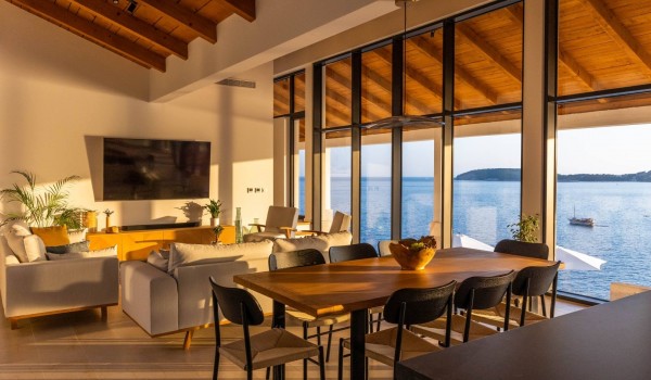 Living room in Dubrovnik luxury family villa by the sea with dining table and sofa.
