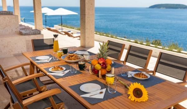 Outdoor dining area on the terrace of Croatia luxury villa Crystal Palace in Duborvnik with infinity pool.