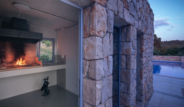 Outdoor fireplace and private pool in the luxury family villa Aromatica in Dubrovnik on Sipan island for vacation and rent