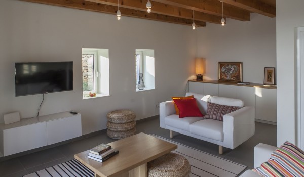 Living room area with the smart LCD TV and sofas in luxury family villa Aromatica on Sipan island