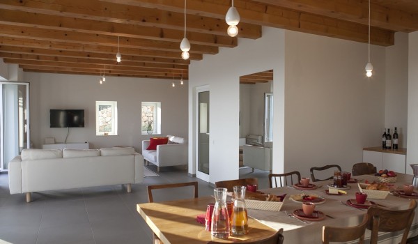 Living room area with smart LCD TV connected with dining area in the luxury holiday villa Aromatica in Dubrovnik for vacation and rent