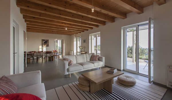 Living room area with the smart LCD TV and sofa in luxury family villa Aromatica on Sipan island