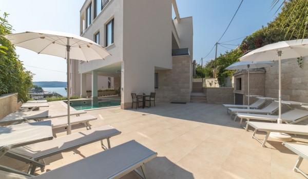 Deck chairs by the pool on the terrace of a Croatia luxury vacation villa with gym and sauna in Trogir
