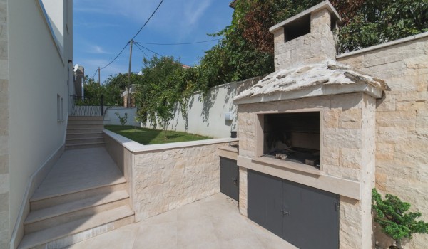 Traditional  grill on the terrace of a Croatia luxury family villa with private pool and sea view in Trogir