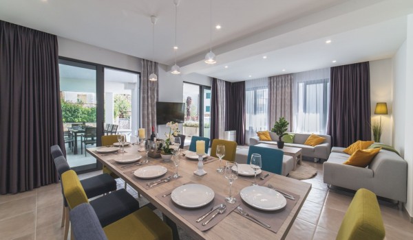 Living room with comfortable sofas and dining table in a Croatia luxury family villa Trogir 3 with private pool and sea view