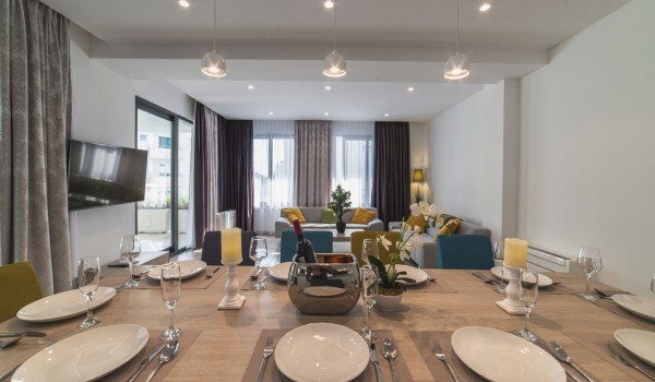 Living room with comfortable sofas and dining table in a Croatia luxury family villa Trogir 3 with private pool and sea view