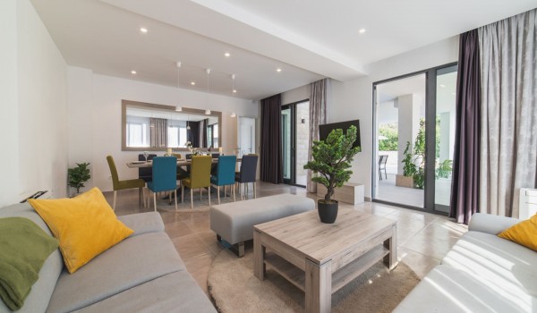 Living room with comfortable sofas and dining table in a Croatia luxury family villa Trogir 3 with private pool and sea view