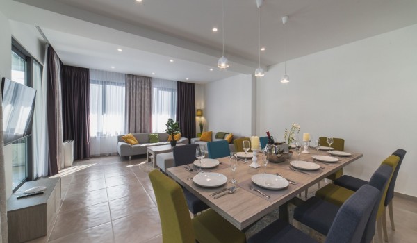 Living room with comfortable sofas and dining table in a Croatia luxury family villa Trogir 3 with private pool and sea view