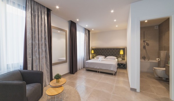 King size bed in a bedroom with en suite bathroom of a Croatia luxury vacation villa with private pool and parking